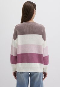 Knit sweater with purple, pink, and white horizontal stripes. Features a round neck and long sleeves, with a relaxed fit and ribbed cuffs.