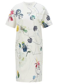 Blommönstrad T-shirtklänning i krämfärg, med avslappnad passform, korta ärmar och rund halsringning. Dekorerad med färgglada abstrakta mönster.