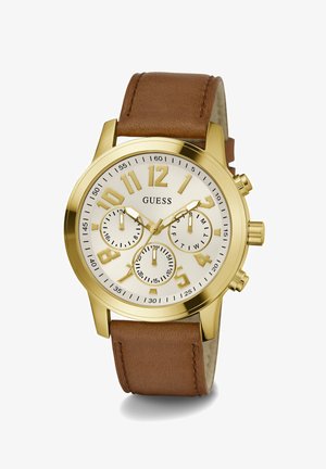 Aukso tono chronograph laikrodis su baltu ciferblatu, dideliais numeriais, rudos odos dirželiu ir subskaitomis sekundžių ir minučių stebėjimui.