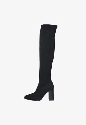 Botas de punto negras hasta la rodilla con tacón cuadrado, punta afilada y acabado texturizado. Presenta un puño acanalado en la parte superior para un mejor ajuste.