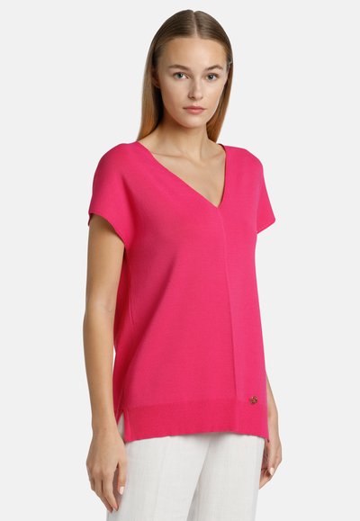 Bright pink, short-sleeve sweater with a V-neck and ribbed hem, featuring side slits and subtle side logo detail. Soft knit material.