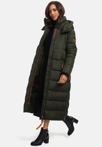 Lang olijfgroene pufferjas met een afneembare capuchon, oranje accenten, gestikt ontwerp, zijzakken en een ritssluiting.