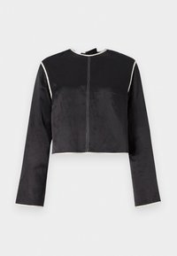 Cropped black satin top with long sleeves, white piping along the neckline and sleeves, and a central seam down the front.