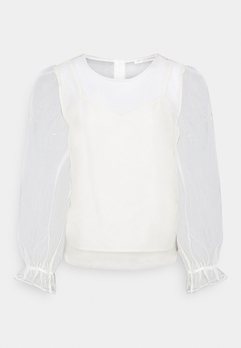 White blouse featuring a fitted, satin-like body and sheer puff sleeves with elastic cuffs. Simple neckline with a back closure.