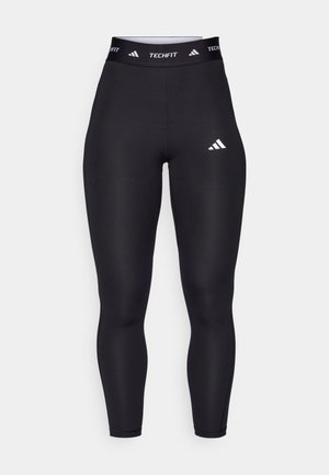 Mustad musta värvi Techfit retuusid kõrge vöökoht, sujuv kangas, millel on valge Adidas logo ja bränding vöökoht.
