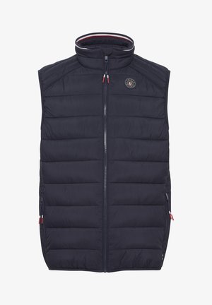 Laivansiniset hihattomat untuvapuserot korkean kaulan kanssa, pystysuora vuorattu muotoilu, sivuvetoketjut ja pyöreä logo rinnassa.