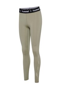 Beige leggings i slim fit med sort elastisk taljebånd med hvid "hummel" tekst og logo samt et diskret chevron-mønster på den nederste del af benet.