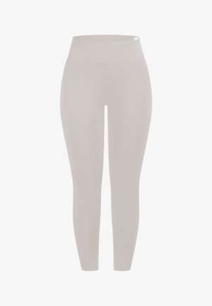 Leggings color beige chiaro a vita alta realizzati in tessuto elasticizzato. Texture liscia, design aderente e lunghezza alla caviglia con una fascia larga in vita.
