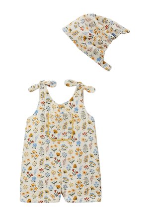 Barboteuse bébé à motif floral avec poche avant et bretelles à nouer, accompagnée d'un bonnet assorti avec dos élastique.