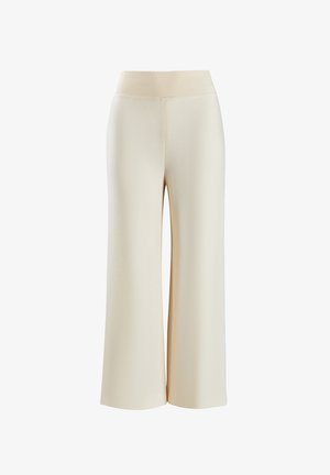 Pantalons à larges jambes de couleur crème, fabriqués dans un matériau doux et extensible avec une taille côtelée. Texture lisse sans motifs ni accents visibles.