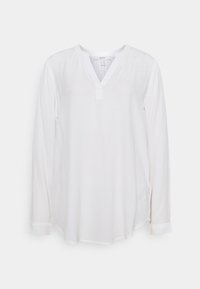 Camicia bianca a maniche lunghe in un tessuto leggero. Presenta una scollatura a V, dettaglio con bottoni al collo e polsini arrotolati, con un orlo leggermente curvo.