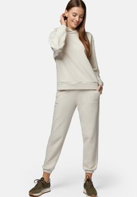 Beżowa bluza z kapturem o luźnym kroju z prążkowanymi mankietami, w komplecie z pasującymi joggerami z elastycznym pasem i mankietami.
