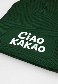 Green knit beanie with a textured pattern, featuring a rectangular label that reads "Ciao Kakao" in bold white letters.