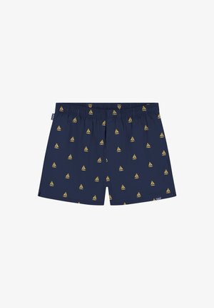 Navyblauwe zwembroek voor heren met geel zeilbootpatroon, elastische tailleband en kleine merklabels aan de linkerkant en onderzoom.