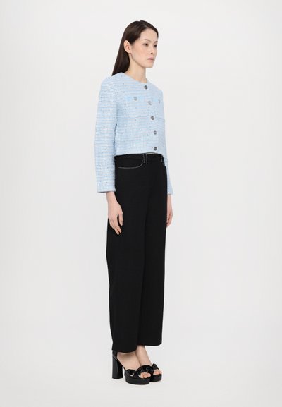 Blue tweed jacket with silver buttons, paired with black wide-leg trousers and black platform heels with bows. Smooth, textured fabrics.