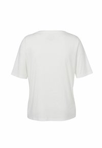T-shirt en coton blanc à manches courtes, encolure arrondie et coupe décontractée. Texture lisse, design simple, sans logos ni motifs visibles.