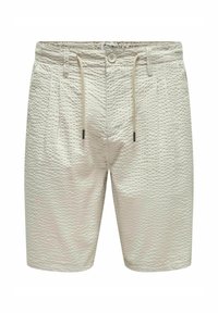 Beige teksuuriga lühikesed püksid, millel on sidumisnöör, nööbiga sulgemine ja kaks esitaskut. Kangas on tõstetud, täppide mustriga.