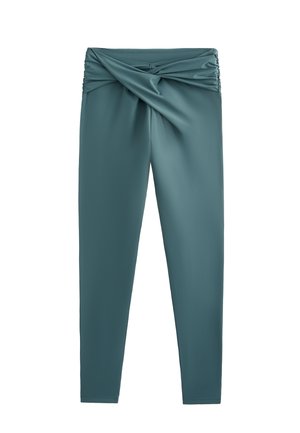 Türkiz leggings, fodros, csavart derékpánttal. Simogató, rugalmas anyagból készültek. Elegáns, testhezálló siluett.
