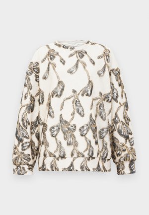 Sweat-shirt crème à manches longues présentant un motif de feuilles et de branches noir et or sur l'ensemble, avec un col rond.