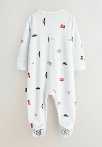 Vit bomullsbody med ett mönster av ikoniska symboler från London, inklusive en vakt, en röd buss och en svart taxi. Rundade muddar med tryckta detaljer.