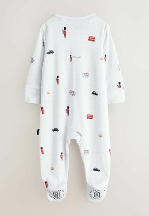 Bela bombažna enodelna obleka z vzorcem londonskih ikon, vključno z varnostnikom, rdečim avtobusom in črnim taksijem. Zaokrožene manšete s potiskanim detajlom.