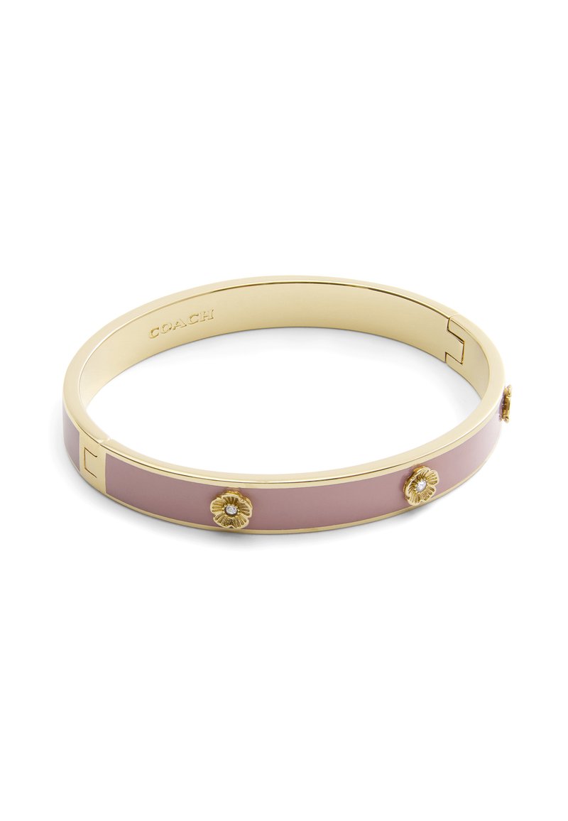 Gold-tone bangle bracelet featuring a smooth pink enamel band. Notable floral accents with embedded crystals enhance the design.