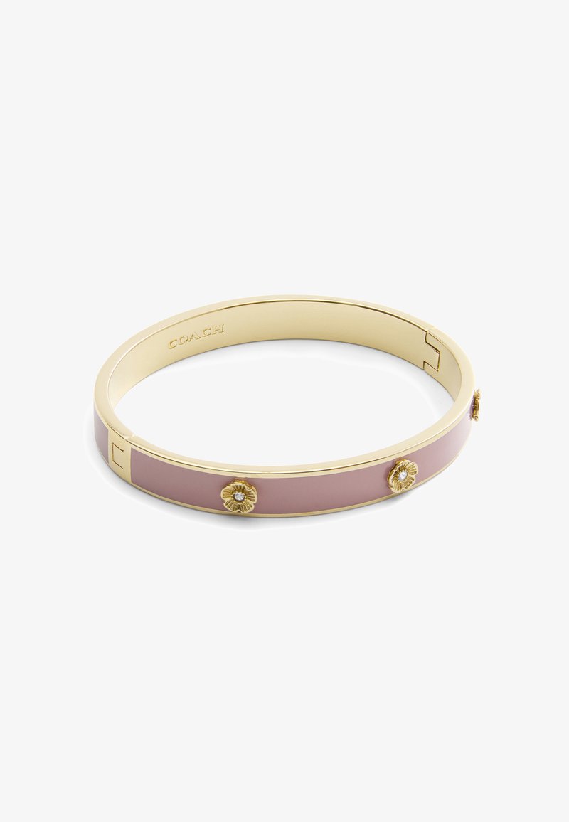 Gold-tone bangle bracelet featuring a smooth pink enamel band. Notable floral accents with embedded crystals enhance the design.