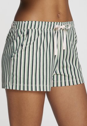 Shorts a righe verdi e bianche realizzati in tessuto morbido. Presentano una vita elastica, un cordino e tasche laterali per maggiore comodità.