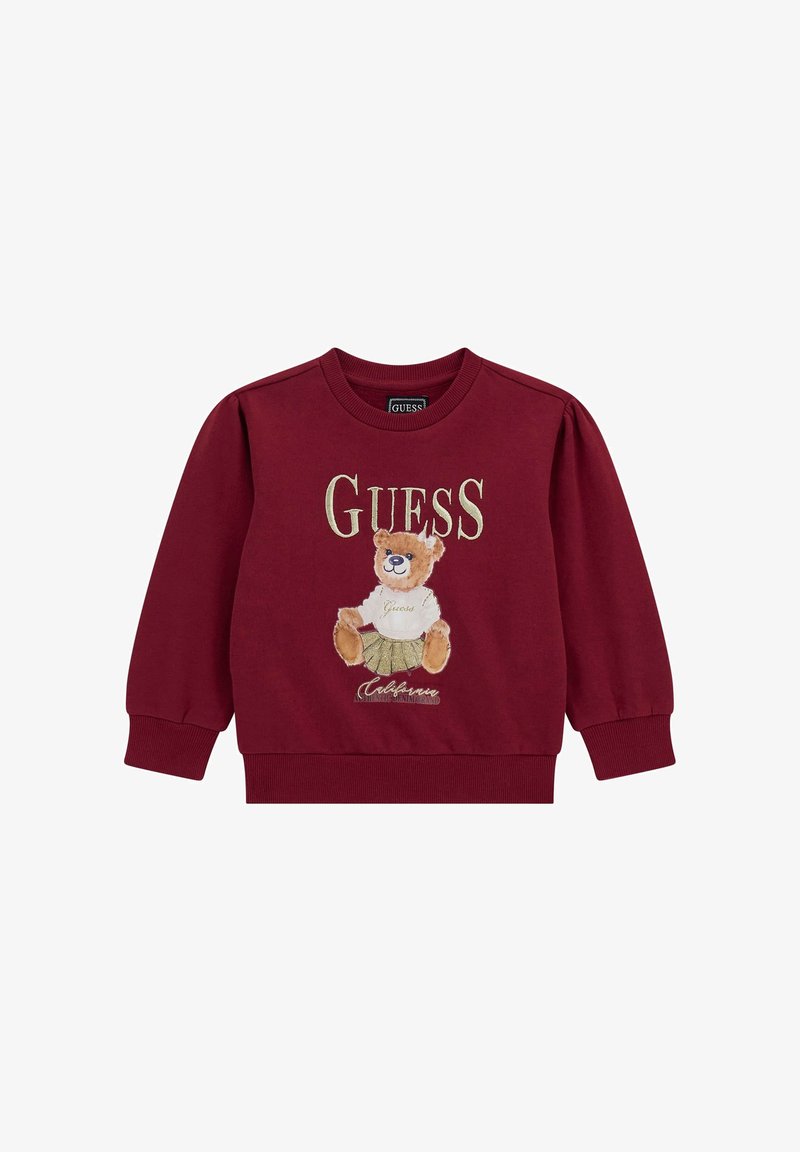 Burgundijas krāsas džemperis ar lāča izšuvumu, "GUESS" logo un ribotām stila piedurknēm un apakšmalu. Mīksta kokvilnas auduma, ar brīvu piegriezumu.