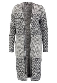 Stickad lång cardigan i svart och vitt, med mönstrade paneler, öppen framsida, två framfickor och en avslappnad passform.