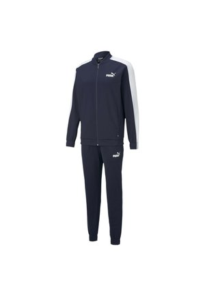 Granatowy dres Puma z białymi paskami na rękawach, kurtka na zamek, elastyczne mankiety i logo Puma na piersi i udzie.