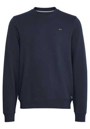 Jūrų laivyno megztinis, pagamintas iš medvilnės, su apvalia kaklo iškirpte ir kanaliniu audiniu apykaklėse, su mažuoju logotipo ženkleliu ant krūtinės. Lygus paviršius, klasikinis kirpimas.