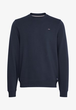 Tumesinine pusakas, valmistatud puuvillast, ümarate kaelustega ja ribakujuliste mansettidega, rinnal väike logo kleebis. Sile tekstuur, klassikaline lõige.