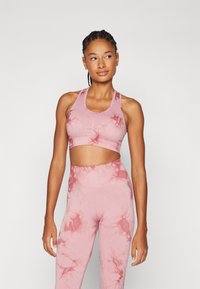 Lys rosa trenings-BH og høyhuset leggings med marmor mønster. Laget av elastisk stoff, med racerback-design og glatt tekstur.