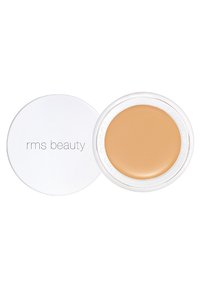 RMS Beauty-kompakt med ett vitt lock, som avslöjar en rund, krämig tan-produkt inuti. Slät textur och naturlig finish synlig.