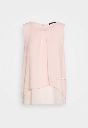 Light pink sleeveless blouse with a layered design, made of smooth fabric, featuring a back zipper and a round neckline.
