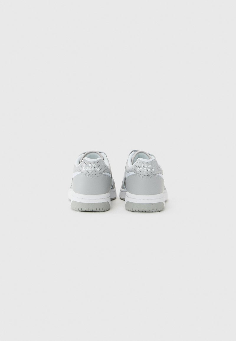 Pair of gray and white New Balance sneakers shown from the back on a plain white background.