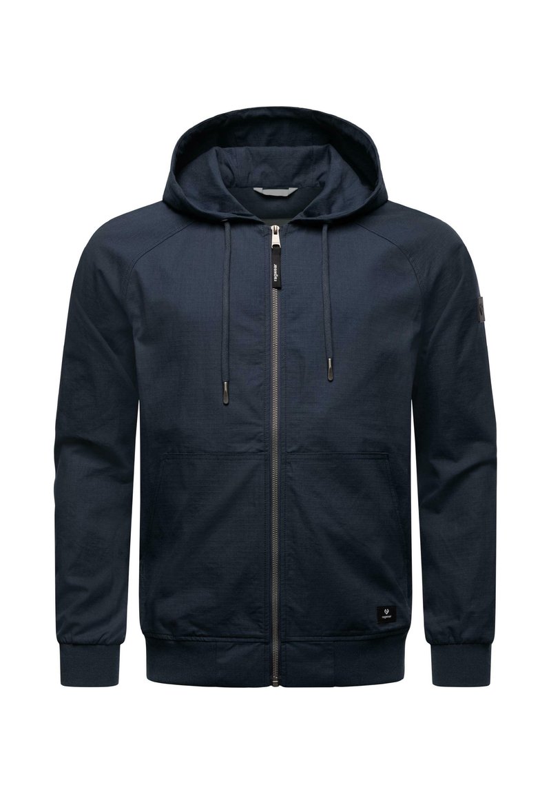 Dark blue zip-up hoodie with a hood, long sleeves, and front pockets. Features a textured fabric and black logo patch on the lower left side.