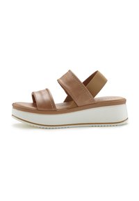Brown leather platform sandal with two wide straps, elastic ankle band, white rubber sole, and subtle stitching details.