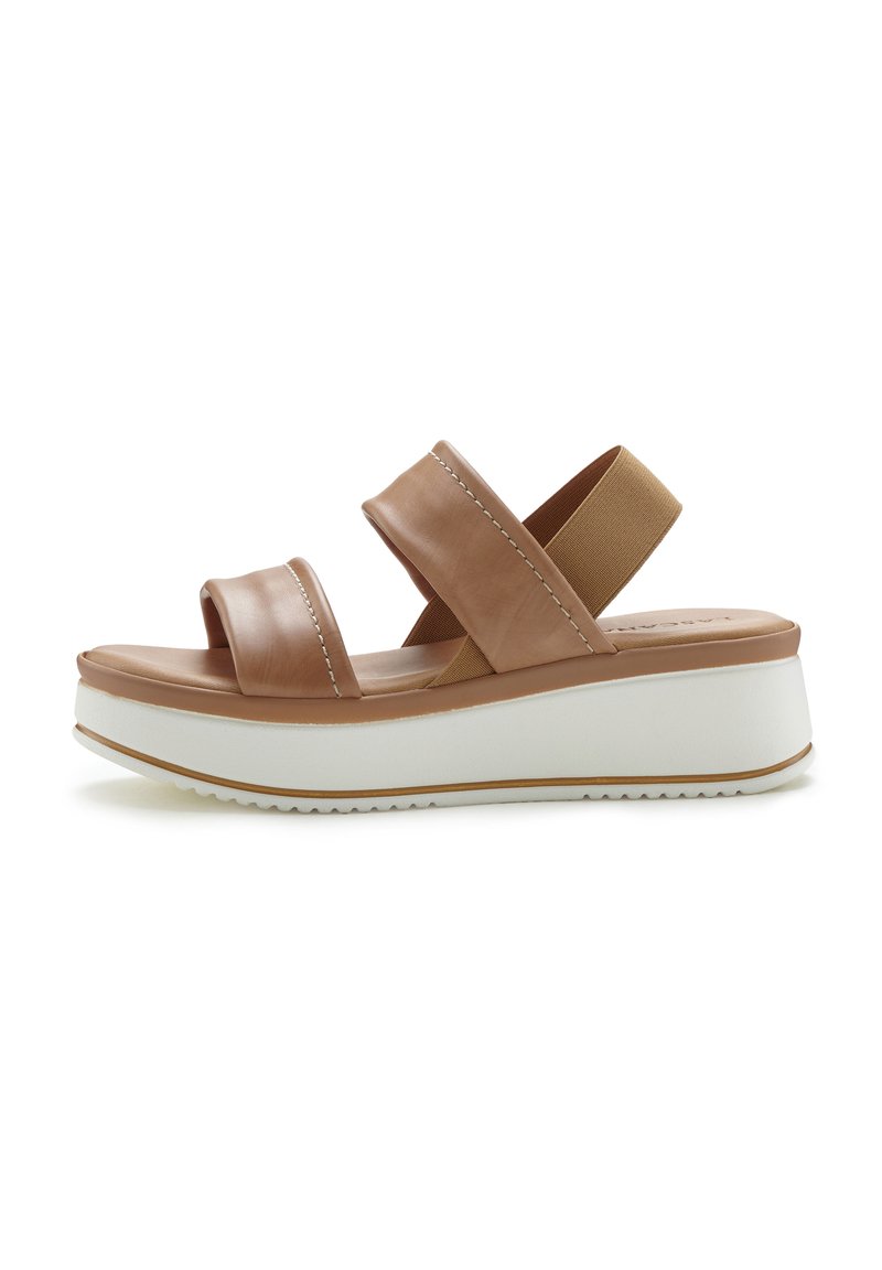 Brown leather platform sandal with two wide straps, elastic ankle band, white rubber sole, and subtle stitching details.