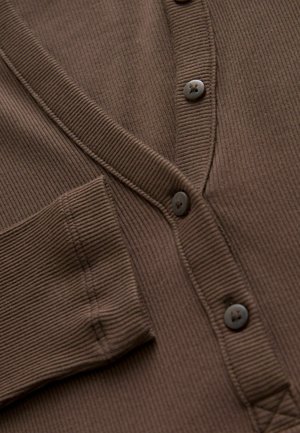 Brown ribbed cardigan features a V-neck, two buttons, and a front pocket. The fabric has a textured finish with subtle vertical lines.
