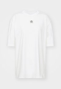 Bílý bavlněný tričko s krátkým rukávem a kulatým výstřihem. Obsahuje malé černé logo Adidas na hrudi. Uvolněný střih, hladká textura.