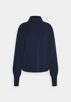 Pull bleu marine à manches longues avec col montant et poignets côtelés, présenté sur un fond neutre.