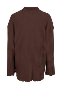 Brun ribbet oversized skjorte med krave, med lange ærmer og en tekstureret overflade. Kantene har en bølget afslutning for et afslappet look.