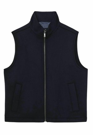 Sötétkék, ujja nélküli mellény, puha anyagból készült, magas gallérral, elülső cipzárral és két oldalsó zsebbel a praktikum érdekében.