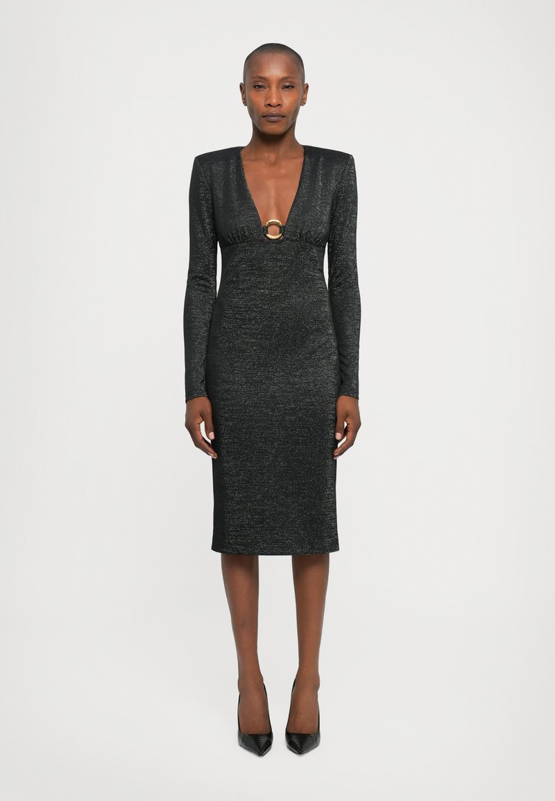 Black long-sleeve dress with a deep V-neck, adorned with a round gold accent at the waist, fitted shape, and textured fabric.