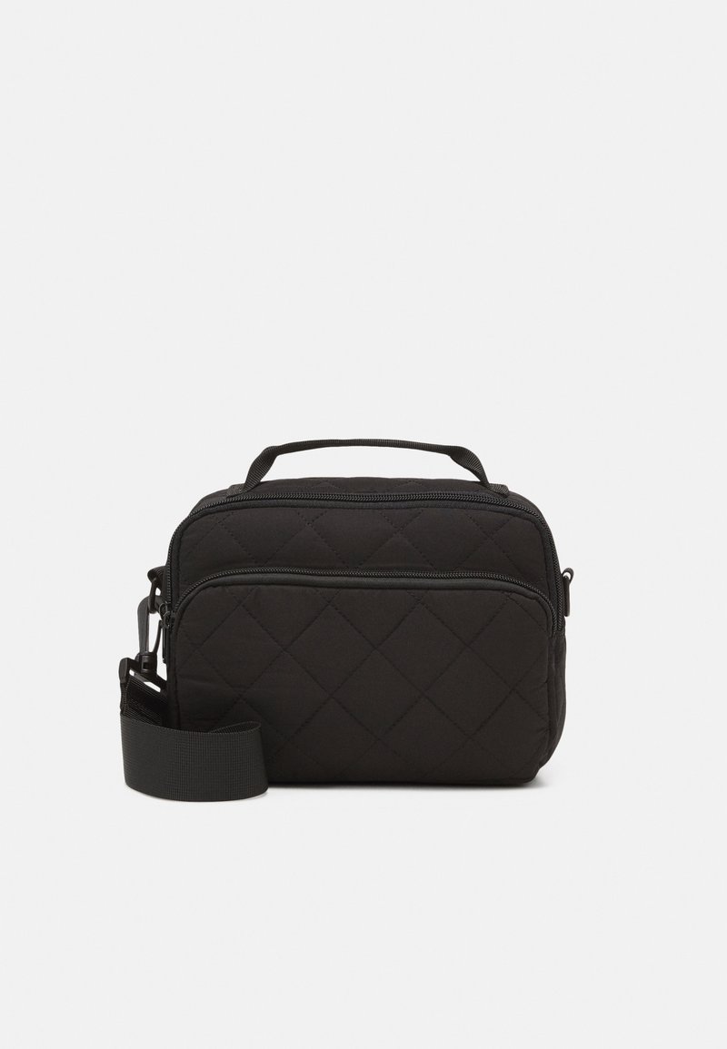 Sac bandoulière matelassé noir avec poche avant zippée, poignée supérieure et bandoulière réglable sur fond blanc uni.