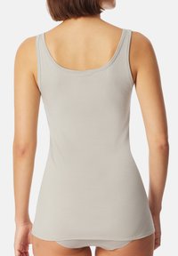 Light gray tank top made of soft, stretchy fabric, featuring narrow shoulder straps and a scoop back design. Smooth texture, simple style.