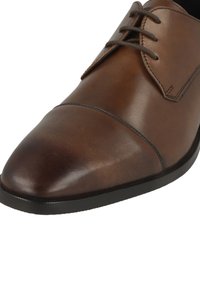 Braune Derby-Schuhe aus Leder mit glatter Textur, runder Spitze und feiner Naht. Sie verfügen über schmale Schnürsenkel und eine elegante schwarze Laufsohle.