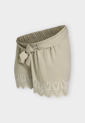 Lysebeige stofshorts med elastisk talje, bundet bælte foran og bølget kant broderet med blonde mønstre.